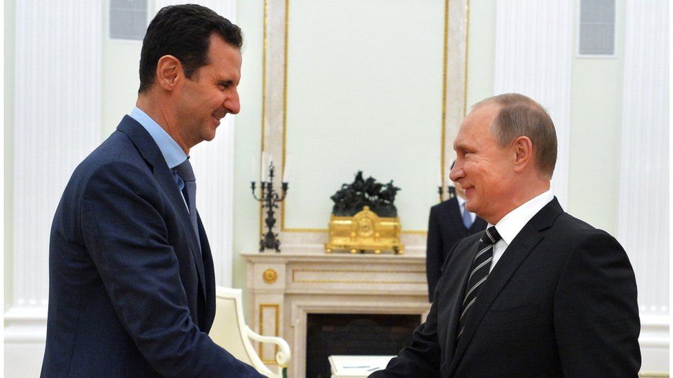 Bashar al-Assad shakes hands with Vladimir Putin in Moscow