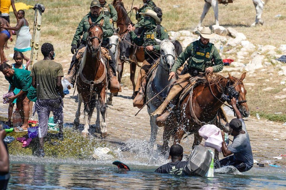 US Border Patrol agents on horseback tries to stop Haitian migrants from entering an encampment on the banks of the Rio Grande near the Acuna Del Rio International Bridge in Del Rio, Texas on September 19, 2021