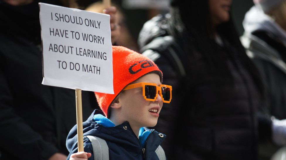Matthew Hale, 6, of Seattle, marches with his family down 4th Avenue during the March for Our Lives rally, 24 March 2018