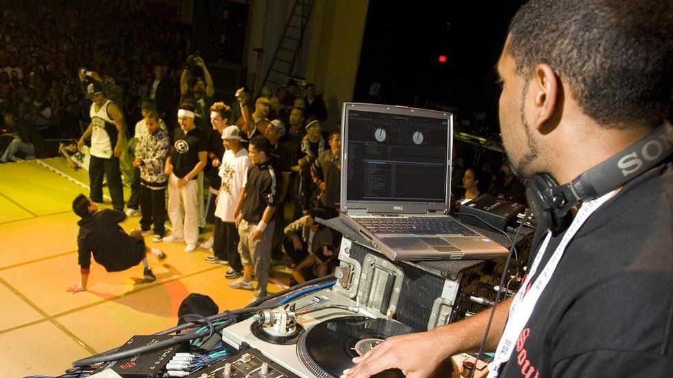 A DJ mixing for a dancer performing at the UK B-Boy championships in 2006