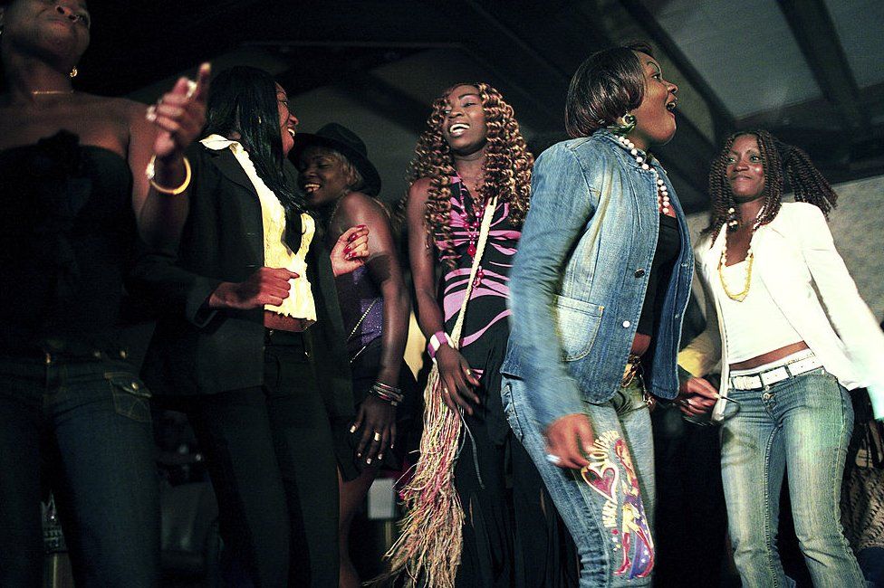 Unidentified women dance next to a stage on April 30, 2006 in central Kinshasa, Congo, DRC.