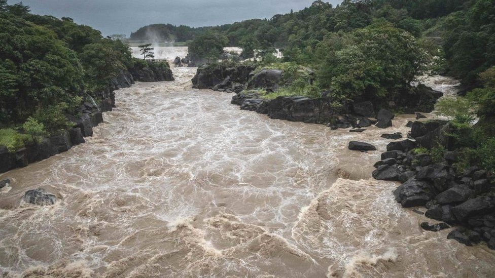 Raging waters flow along the Sendai River in the wake of Typhoon Nanmadol in Isa, Kagoshima prefecture on September 19, 2022.