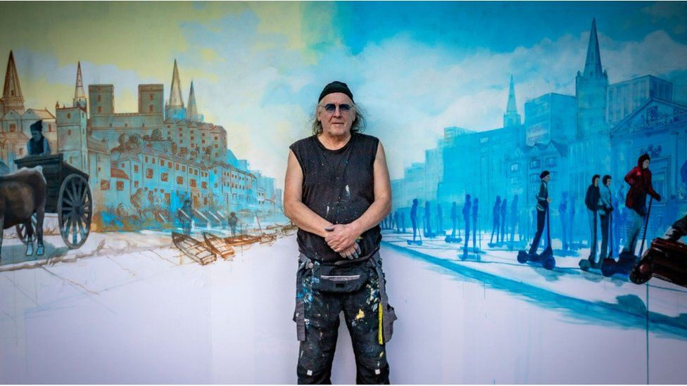Artist in front of painting of Bristol