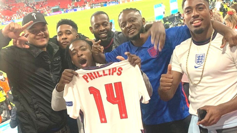 Friends of Kalvin Phillips holding his England shirt after 2-1 win over Denmark
