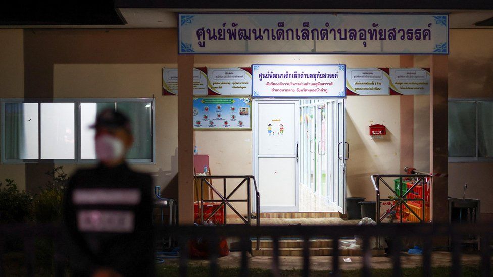 A police officer stands guard outside a day care centre which was the scene of a mass shooting, in the town of Uthai Sawan, around 500 km northeast of Bangkok