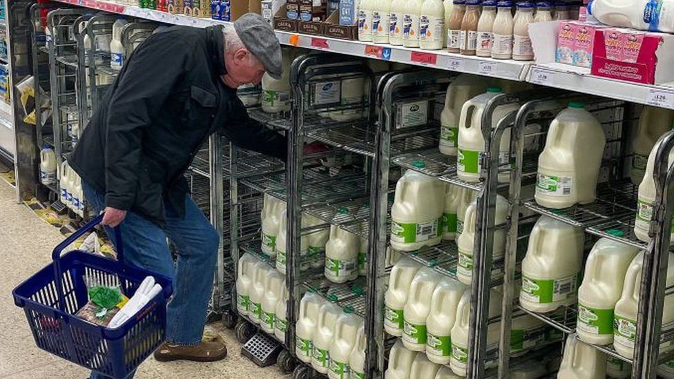 Man shopping for milk at Sainsbury's