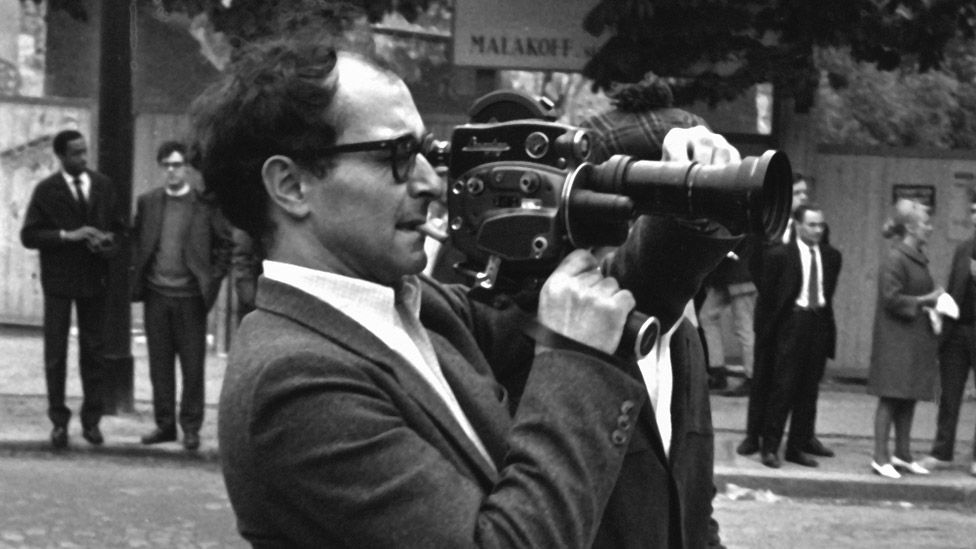 Jean-Luc Godard filming student marches on the streets of Paris in 1968