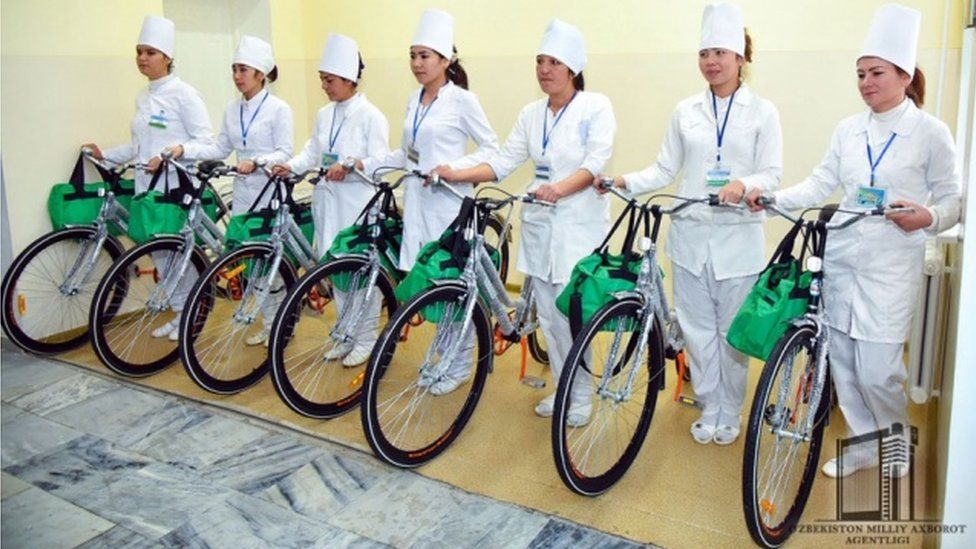 Nurses showing off their new bicycles