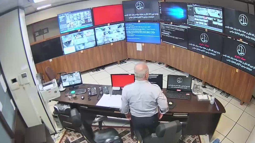 Screengrab of undated video showing man watching hacked screens at Evin prison's control room