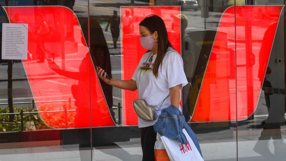 A woman walks past Westpac Bank signage in Melbourne.