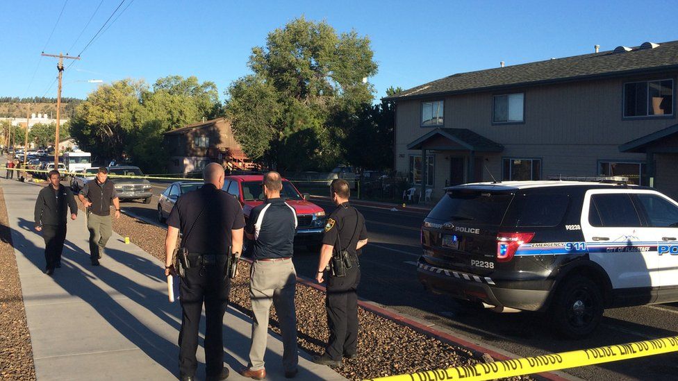 Authorities gather outside the dorm where a shooting incident happened in Arizona on 9 October 2015