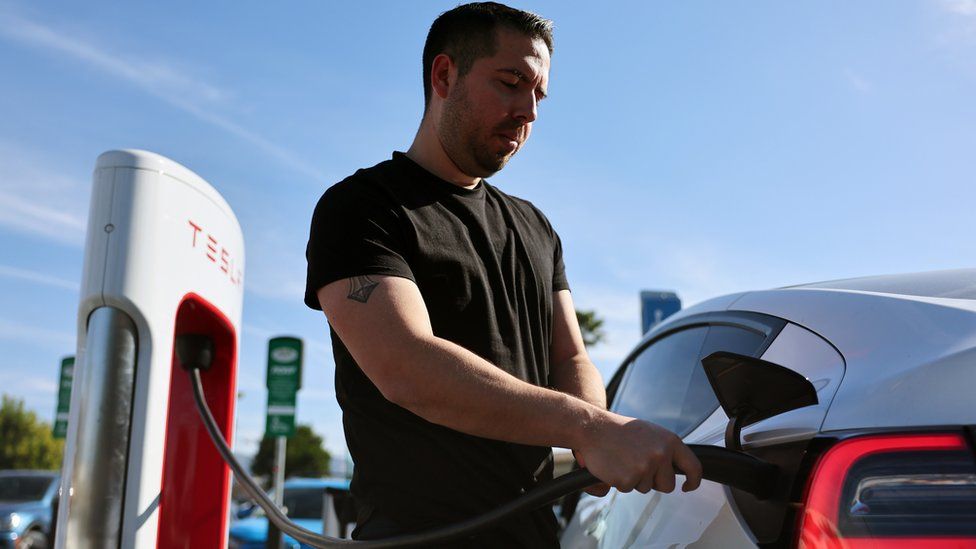 Robert Chavez plugs in his Tesla electric cars to recharge at a Tesla Supercharger station on January 16, 2024 in Burbank, California.