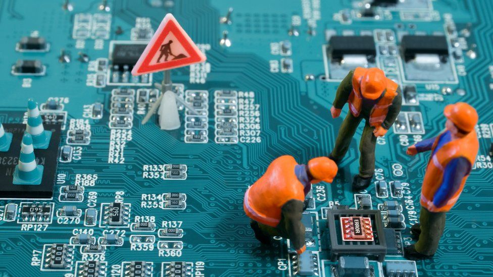 An illustration featuring small model workmen fixing a problem on a circuit board