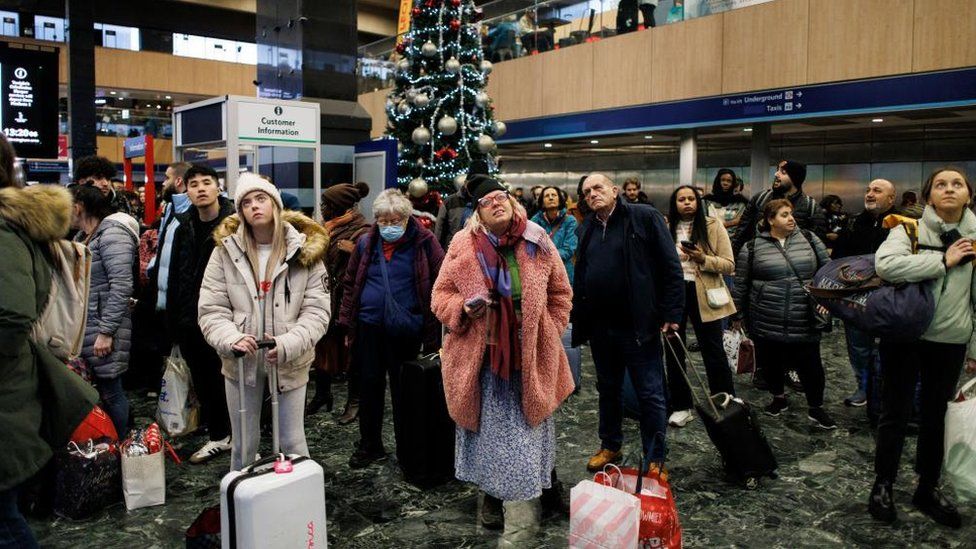 Passengers wait for train services to travel from Euston Station on Friday