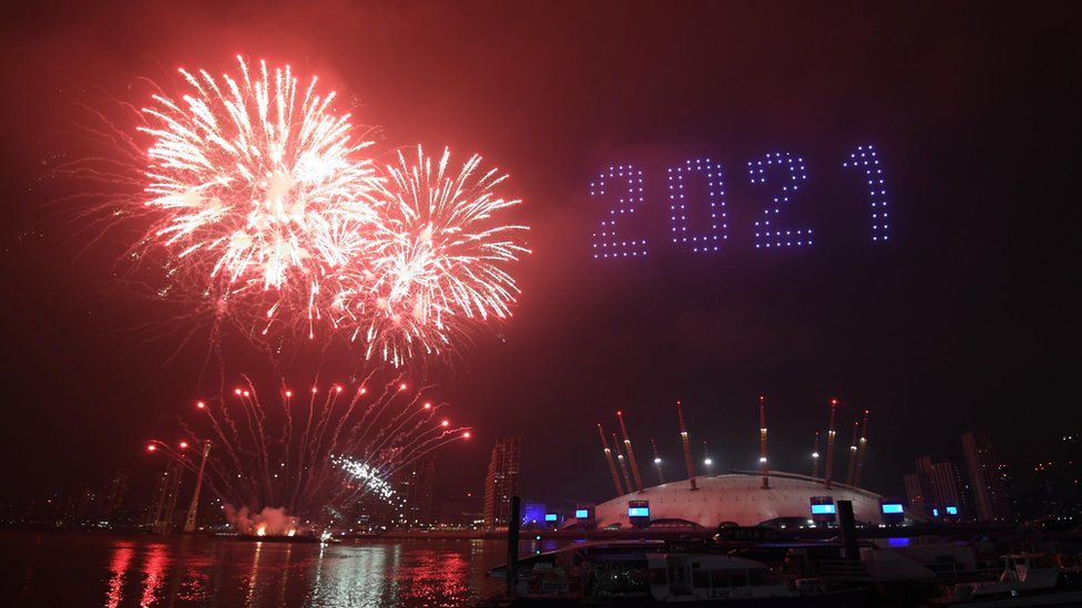 Fireworks and drones illuminate the night sky over the The O2 in London as they form a light display as London"s normal New Year"s Eve fireworks display was cancelled due to the coronavirus pandemic.