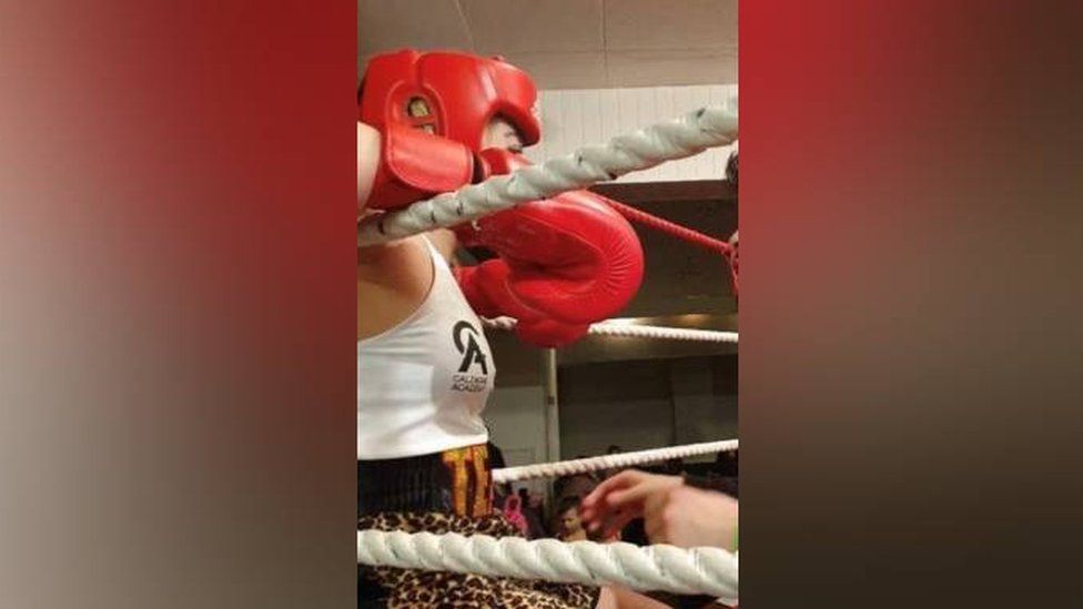 Emma in the boxing ring with her gloves on