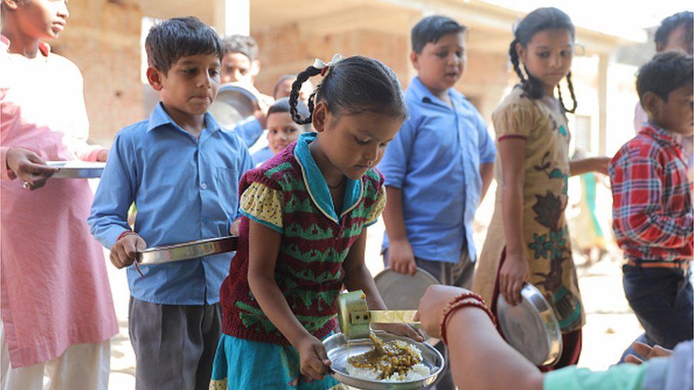 Children receive food served as part of the 'Mid Day Meal' scheme at a government school in rural area of Himachal Pradesh.