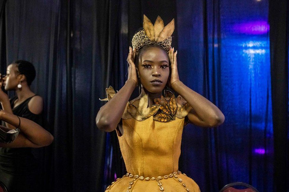 A model gets ready in the backstage area during the third edition of East Africa International Fashion Week in Nairobi, on October 16, 2021. - The annual fashion event created by a former Kenyan model attracts fashion enthusiasts and buyers to see six different collections by designers from Kenya, Uganda and Tanzania.