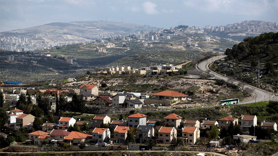 Houses in the Jewish settlement Kedumim in the Israeli-occupied West Bank are seen in the foreground; part of the Palestinian city of Nablus is seen in the background, far left (20 February 2020)
