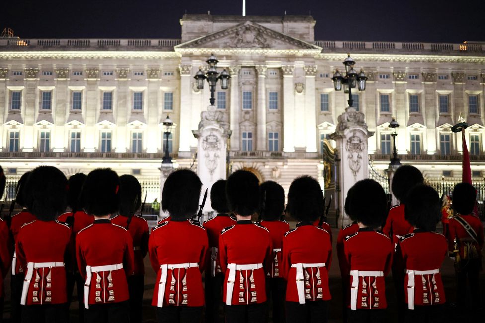 Soldiers stand outside Buckingham Palace, as part in a full overnight dress rehearsal of the Coronation Ceremony.