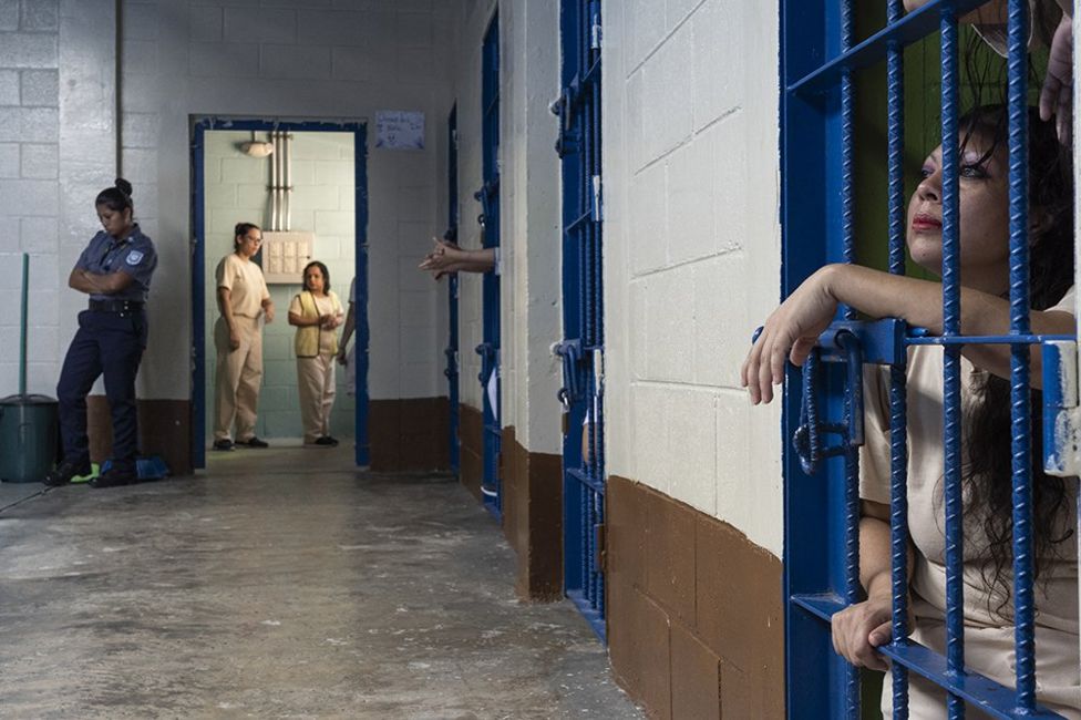 A female inmate looks out of her cell at the Ilopango Women's Prison, ...