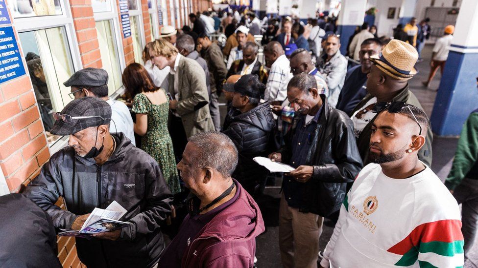 Punters queue to place their bets at the 2022 edition of the Durban July horse race in Durban, on July 2, 2022.