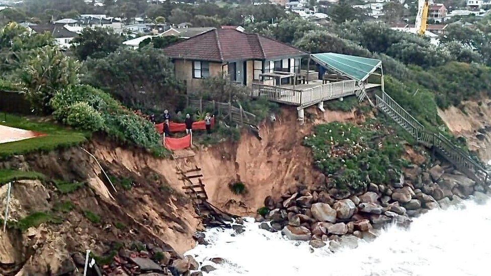 A beachfront home affected by the high waves in Warambel