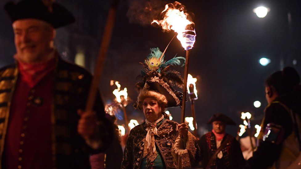 Revellers' torches are carried through the streets of Lewes in East Sussex