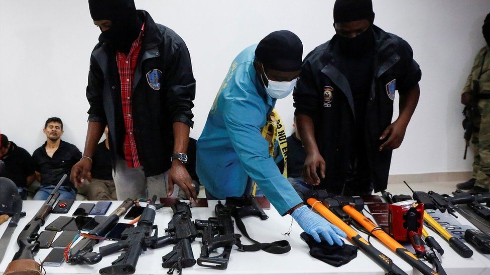 Weaponry, mobile phones, passports and other items were shown to the media along with suspects in the assassination