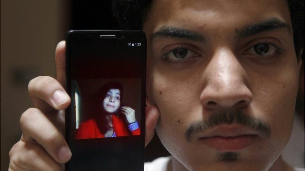 Hassan Khan shows the picture of his wife Zeenat Rafiq, who was burned alive, allegedly by her mother, on a mobile phone at his home in Lahore, Pakistan Wednesday, June 8, 2016.
