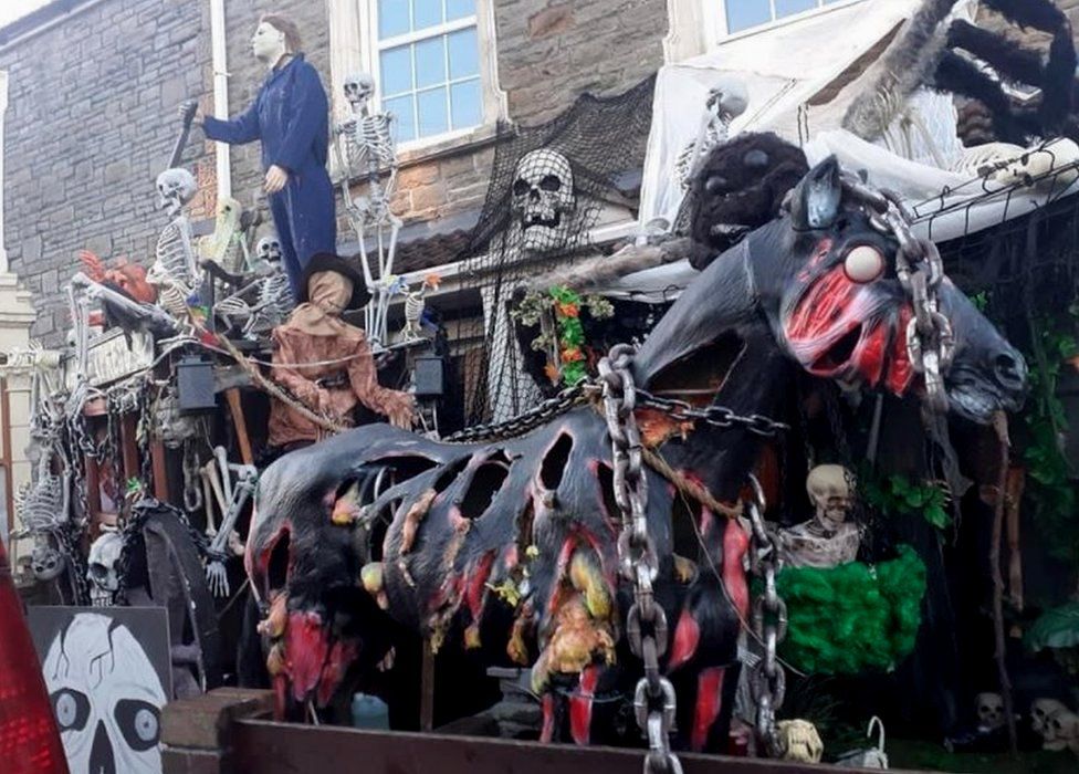 A ghoulish horse drawn carriage Halloween display