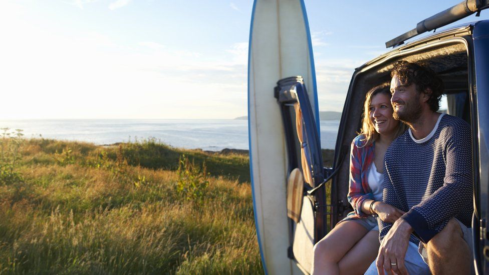 Couple sitting in a campervan