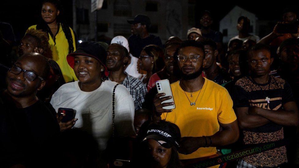 People wait outside a polling station to hear results after polls were closed on election day in Lekki, Lagos, Nigeria February 25, 2023.