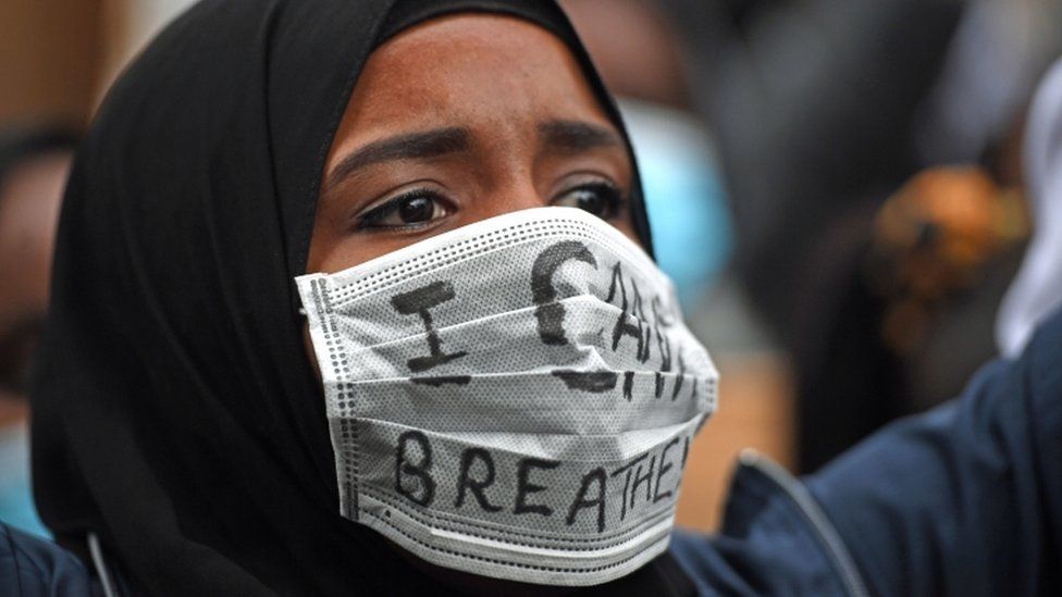 A protester wears a mask