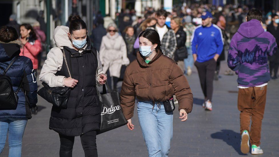 People wearing masks while walking in Dublin city centre.