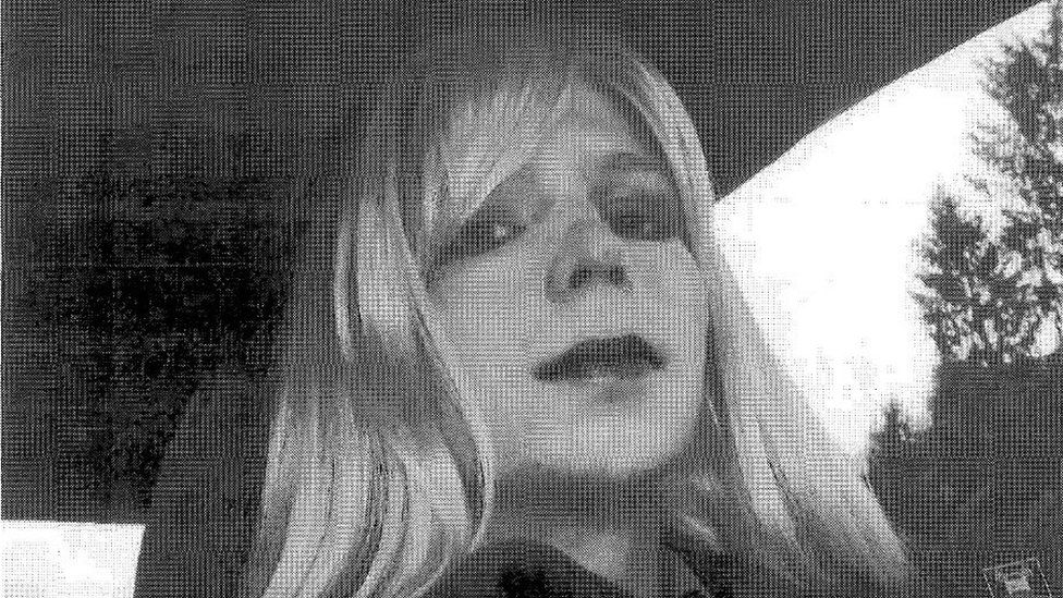 Chelsea Manning wears a wig while sitting in a car