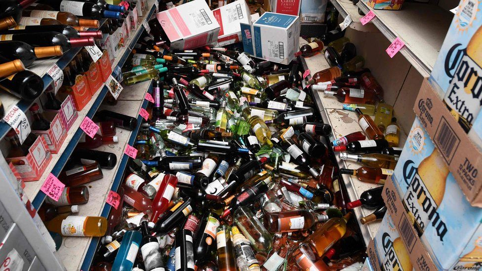 Broken bottles cover the floor of a liquor store in Ridgecrest, California, on July 6