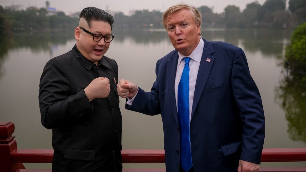Kim Jung-Un impersonator 'Howard X', and Donald Trump lookalike 'Russell White' posing for photos at Ngoc Son Temple in Hanoi, Vietnam