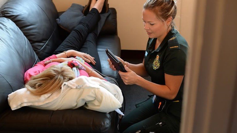 A paramedic assessing a patient with the home equipment