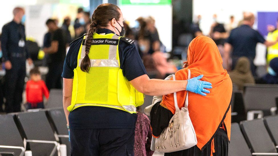 Border Force officer assists Afghan refugee at Heathrow Airport