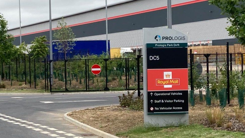 Entrance to large warehouse with Royal Mail sign outside