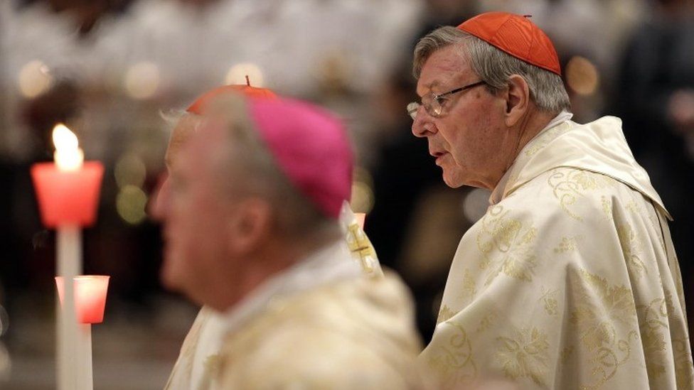 Australian Cardinal George Pell holds a candle as Pope Francis leads the Easter vigil mass in Saint Peter"s basilica at the Vatican, April 15, 2017