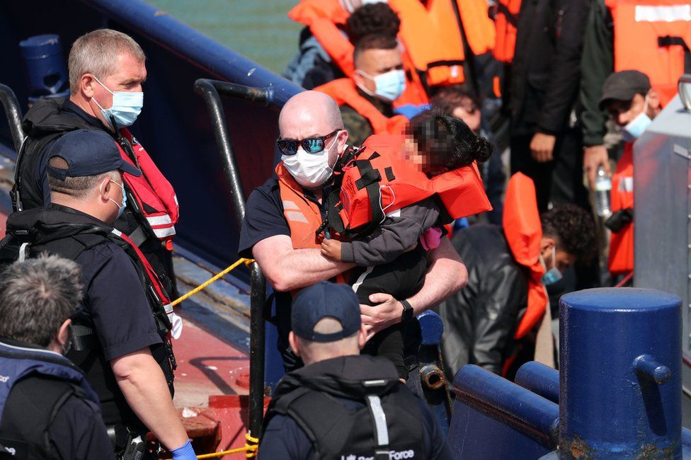 A group of migrants, including children, are brought to Dover on Thursday 3 June