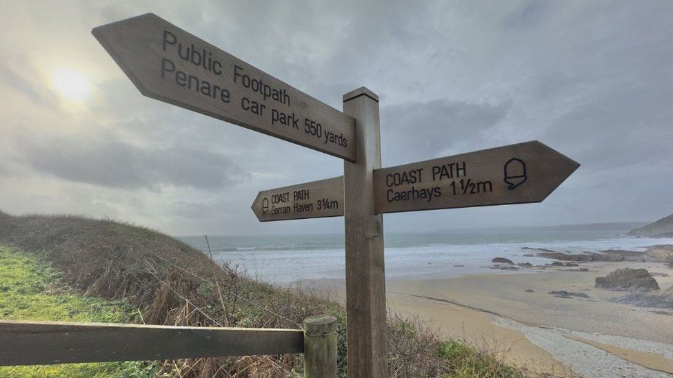 A sign post on the South West Coast Path near Dodman Point in Cornwall
