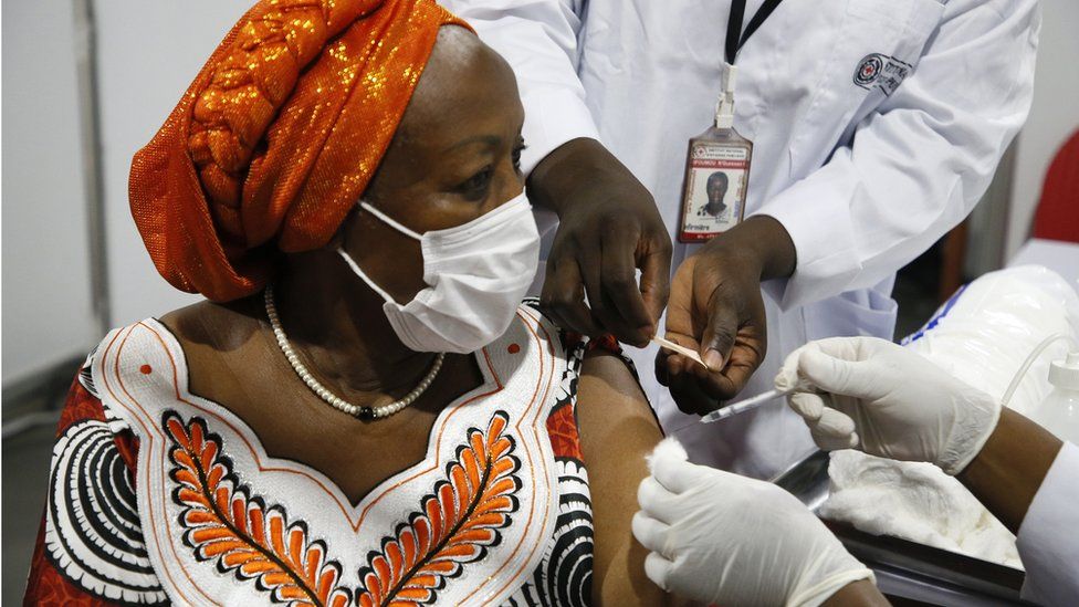 An Ivorian woman receives the first injection of the Covid-19 vaccine, at a vaccination centre in Abidjan, Ivory Coast, 1 March 2021