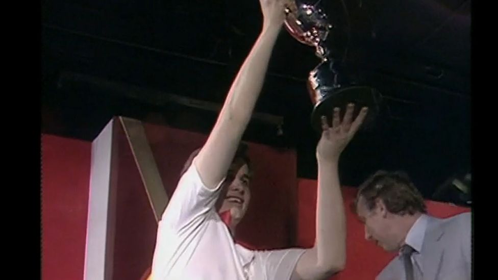 Keith Deller holding his World Darts Championship trophy