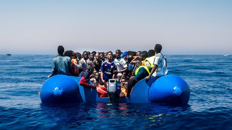 Refugees wait to get on onboard the rescue vessel Golfo Azzurro by members of the Spanish NGO Proactiva Open Arms, after being rescued from a wooden boat sailing out of control in the Mediterranean Sea near Libya on Thursday, June 15, 2017