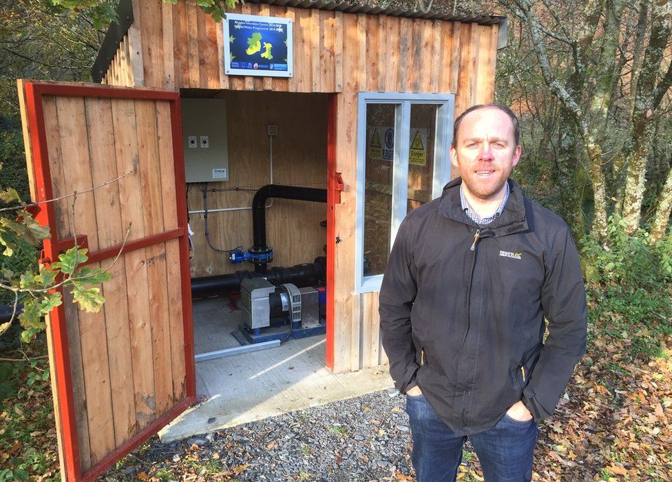 Dr Prysor Williams with the hydropower system in a shed