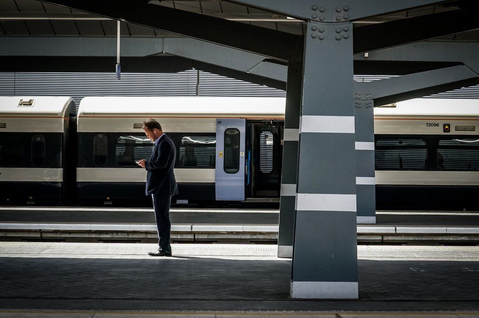 A man standing on a train station platform