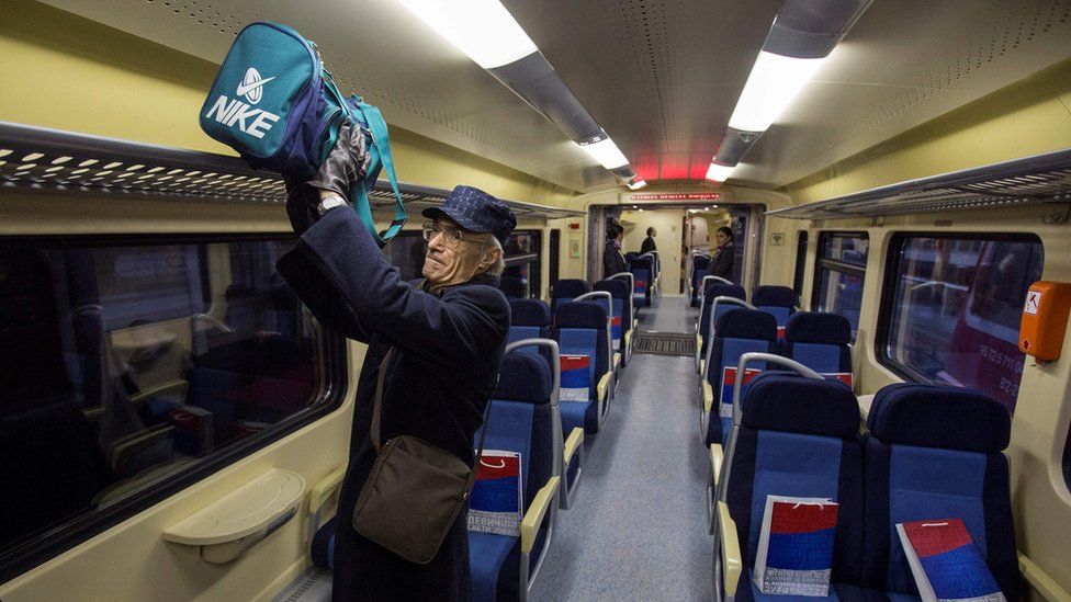 A passenger gets on board the train at Belgrade (14 Jan)